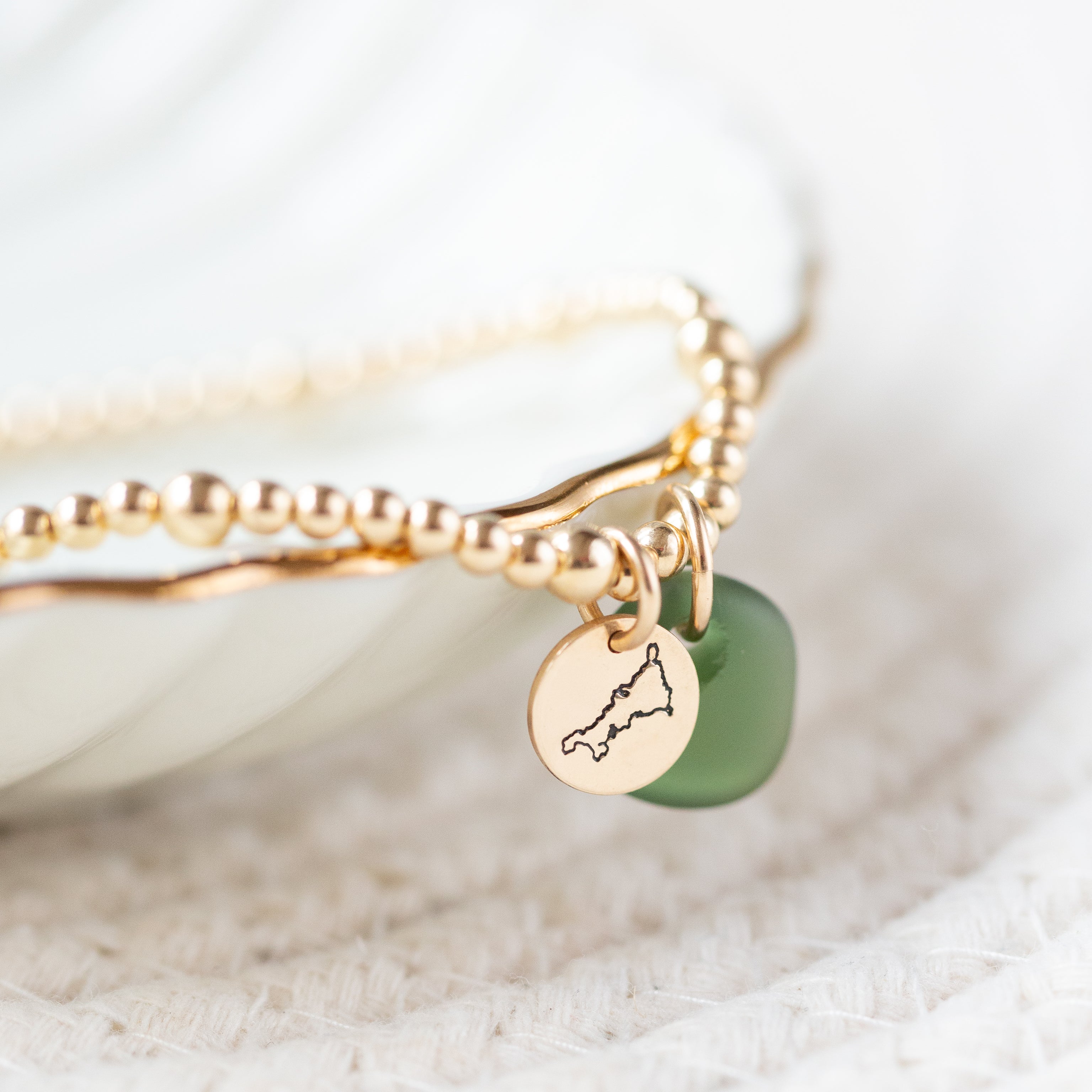 Gold beaded bracelet with a gold mini disc & sea glass